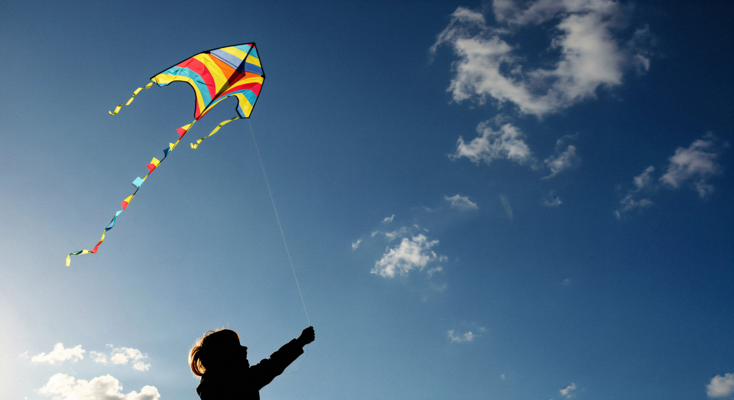 child-playing-with-colorful-kite-sunny-day